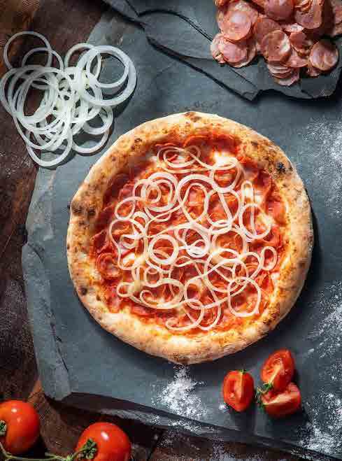 Pizza DeliDay com cebolas sobre ardósia
